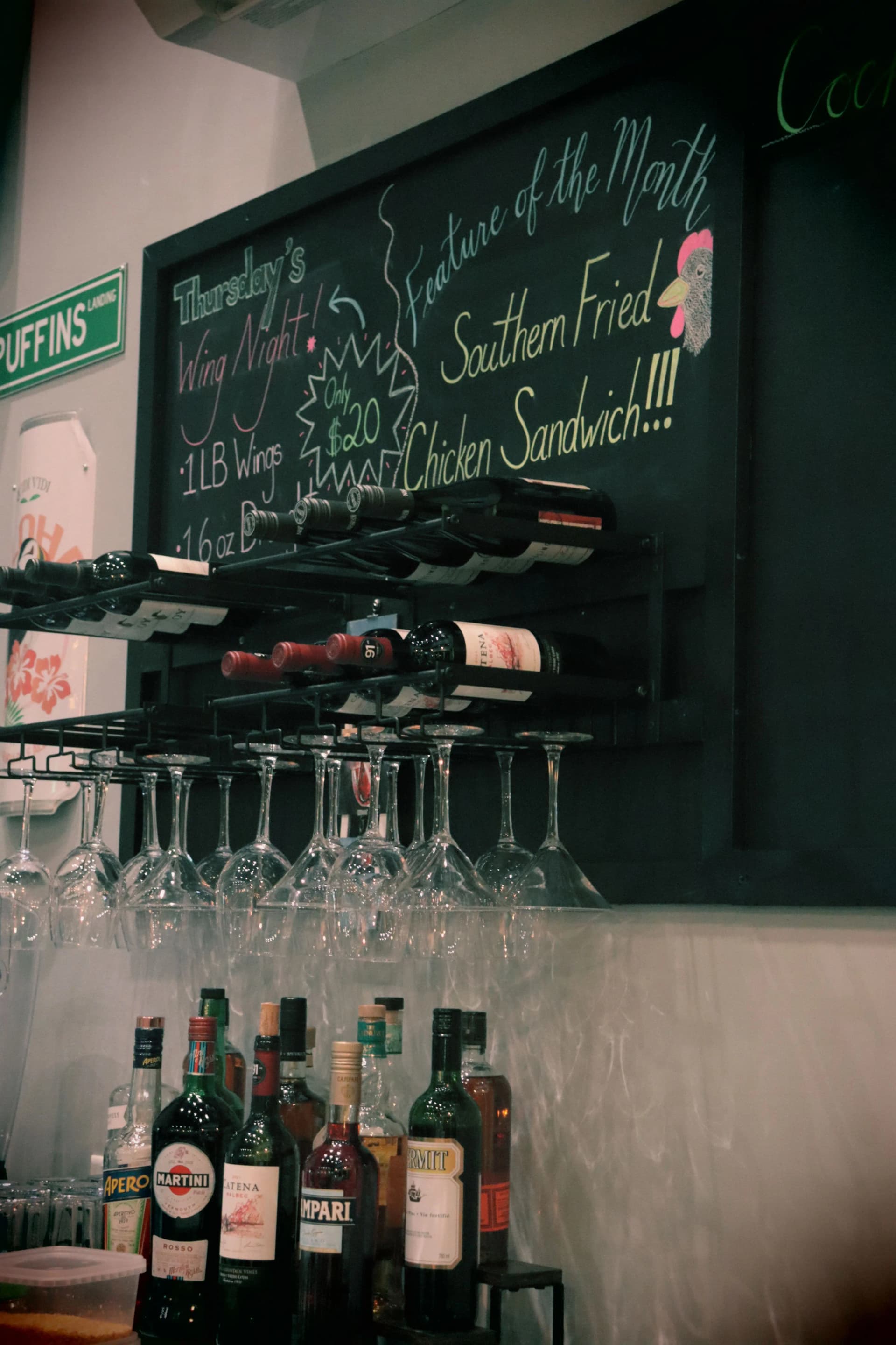 Wine glasses hanging and liquor bottles on a shelf